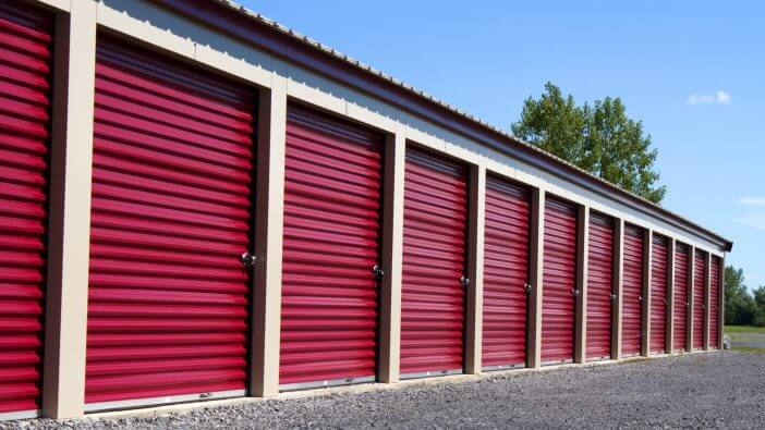 A row of mini rental units for temporary self storage in an outdoor setting.