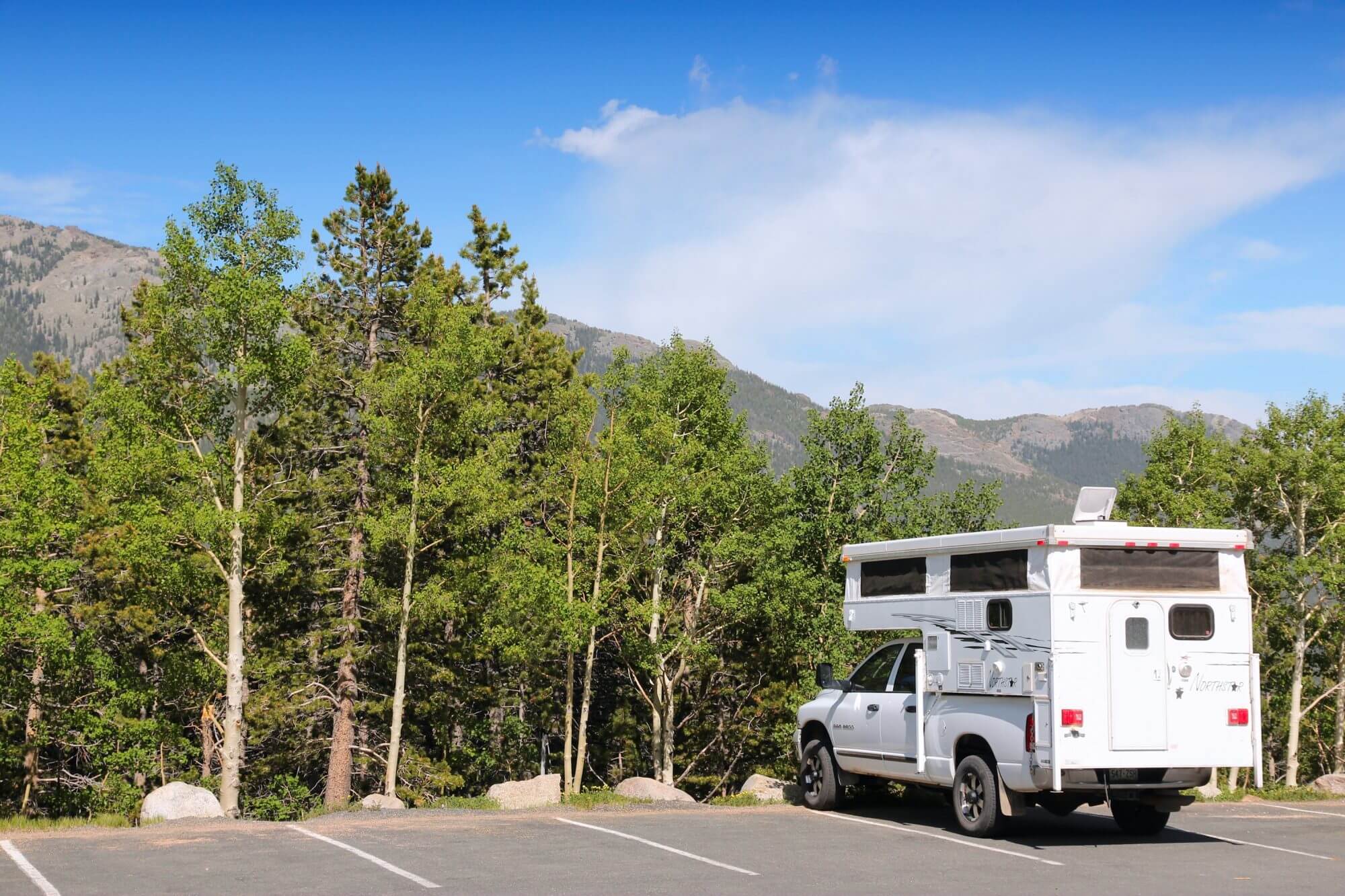 Pickup truck camper with topper shell parked in Rocky Mountain National Park, Colorado. RNMP has 3,176,941 annual visitors (2011).