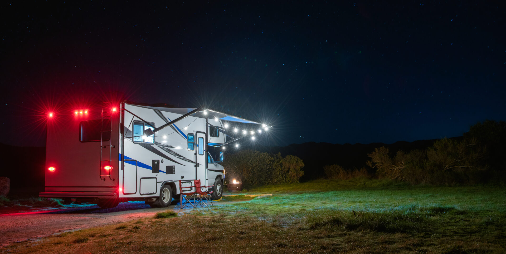 Modern Class C Motorhome Camping Under Starry Sky. RV Travel Theme.