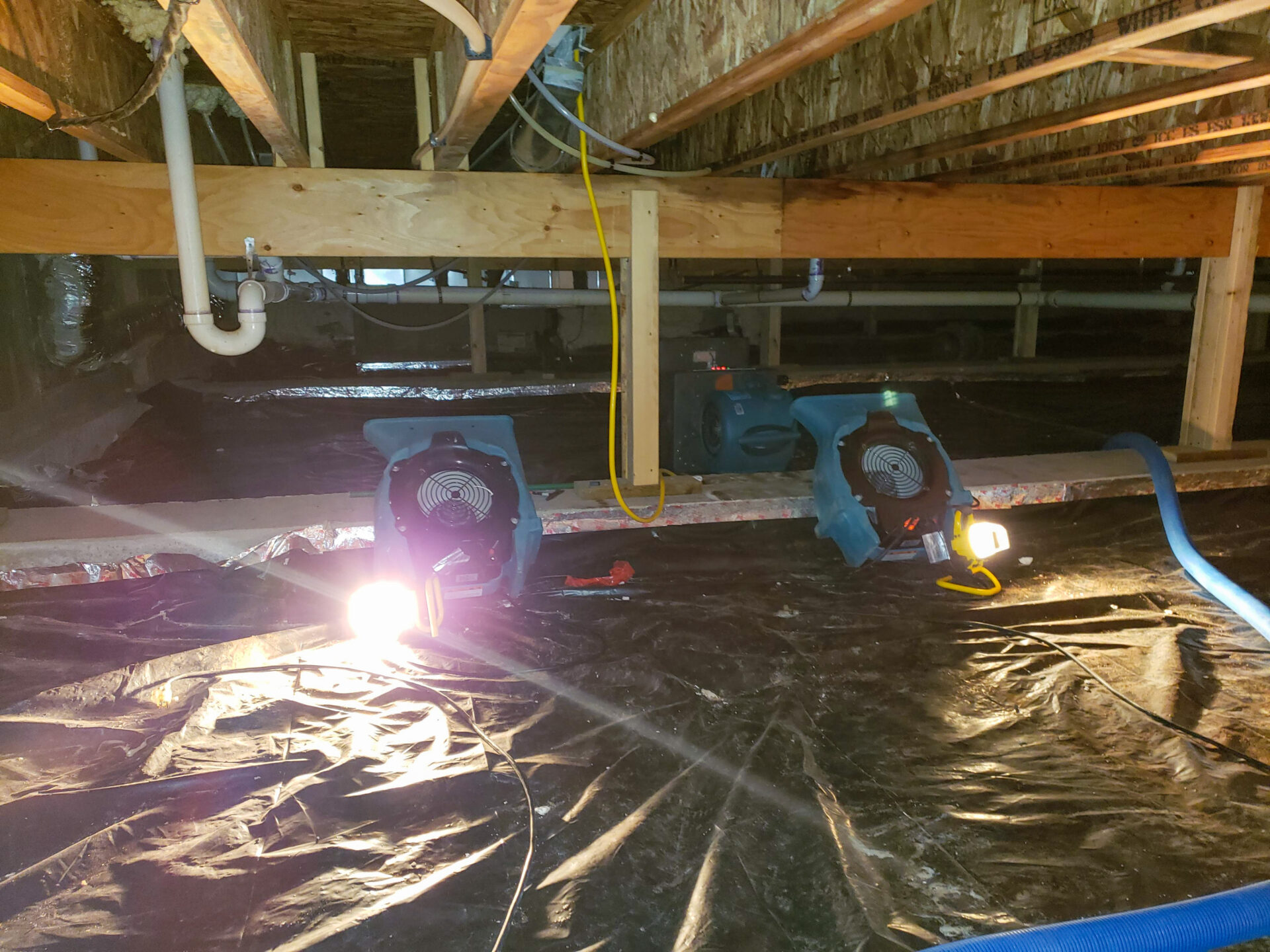 A crawl space with air mover to dry out the structure.