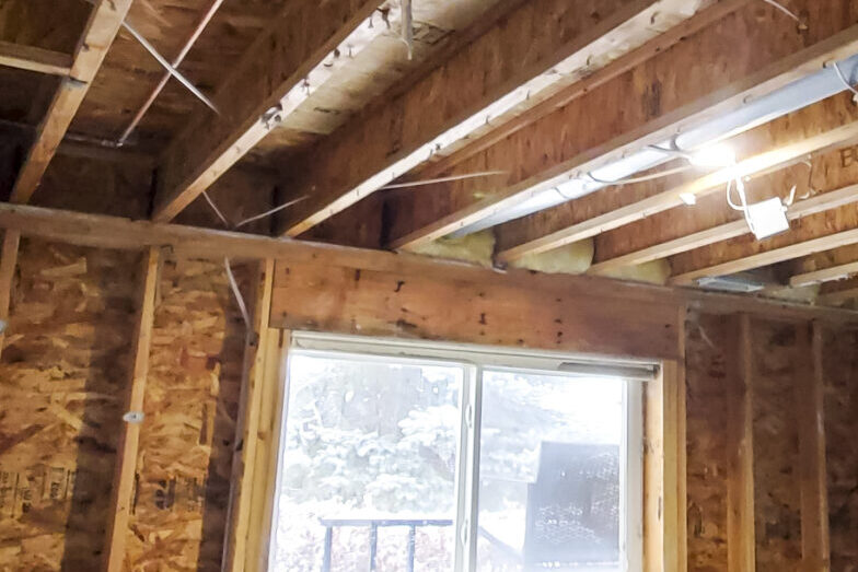 Water damaged room with drywall removed to aid in drying of the structure