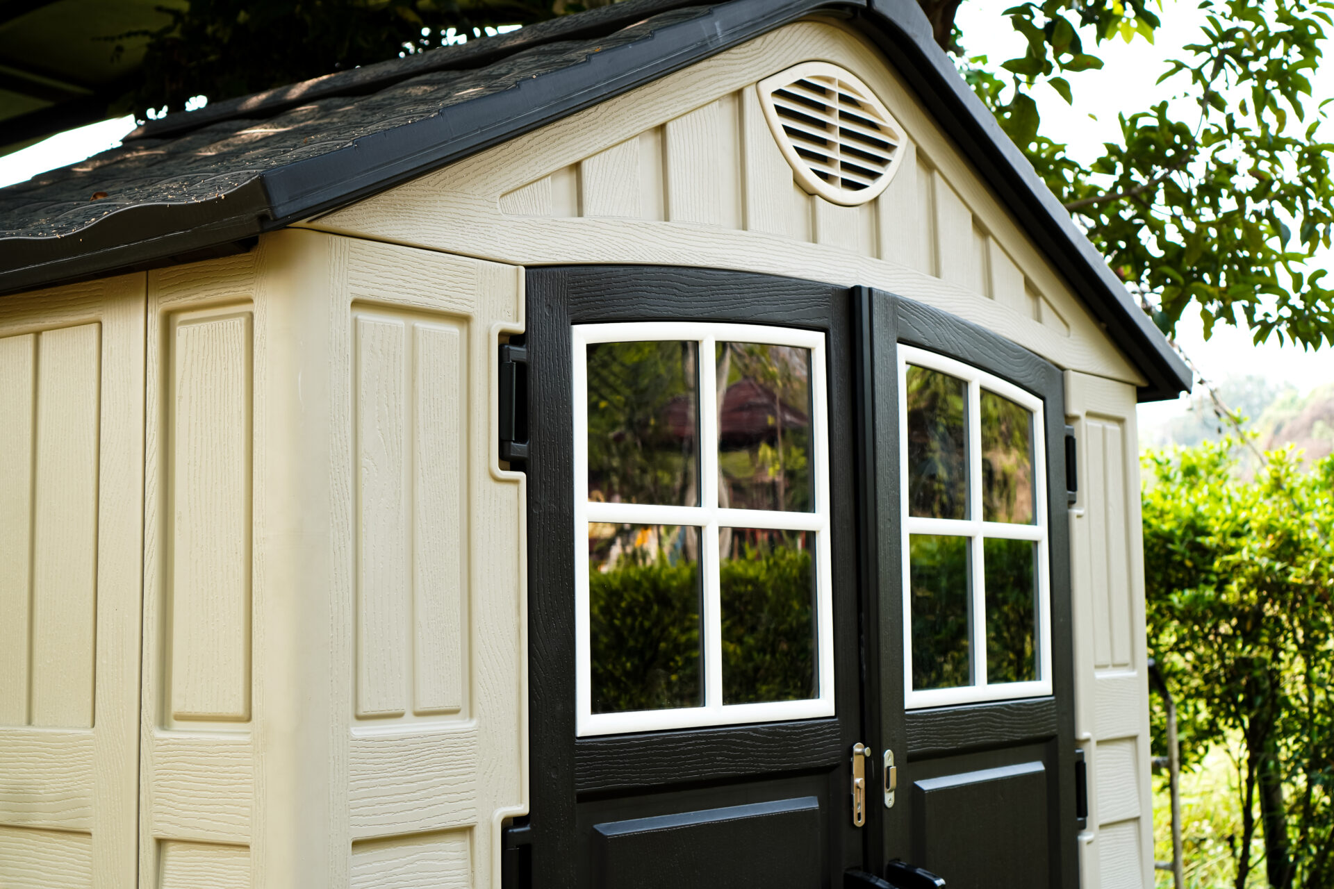 A side view close-up picture showing a small one-story prefab house placed on a playground in a park, Prefab Homes, Sandwich Panel.